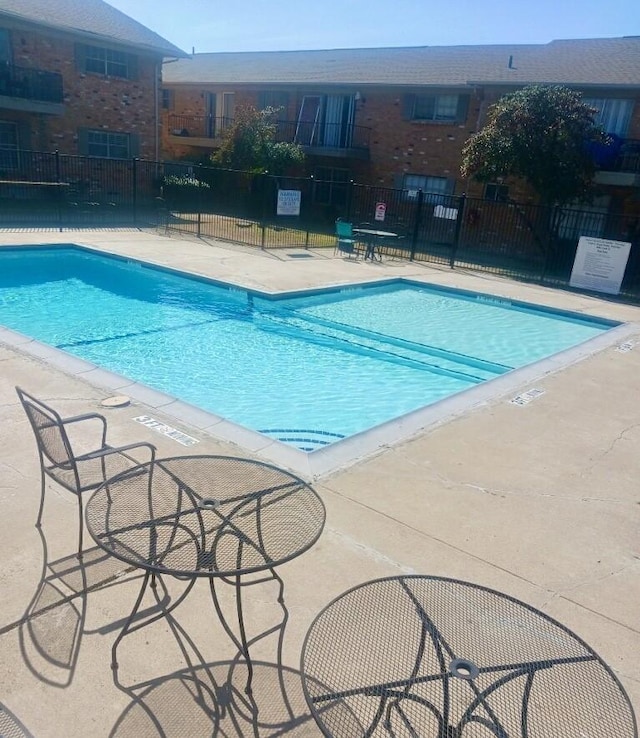 3616 Parkridge Dr Unit 108, Dallas, TX 75234 - view of pool featuring a patio and fence
