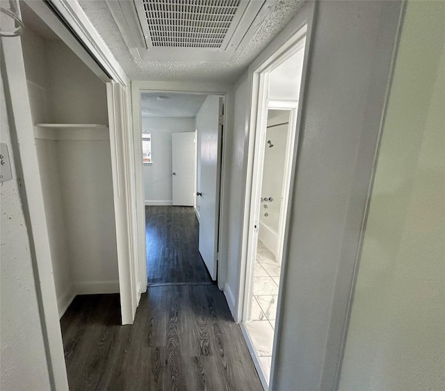 3616 Parkridge Dr Unit 108, Dallas, TX 75234 - corridor with baseboards, dark wood-style flooring, and visible vents