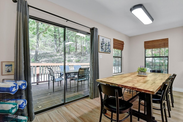 dining area with light wood-style flooring and baseboards