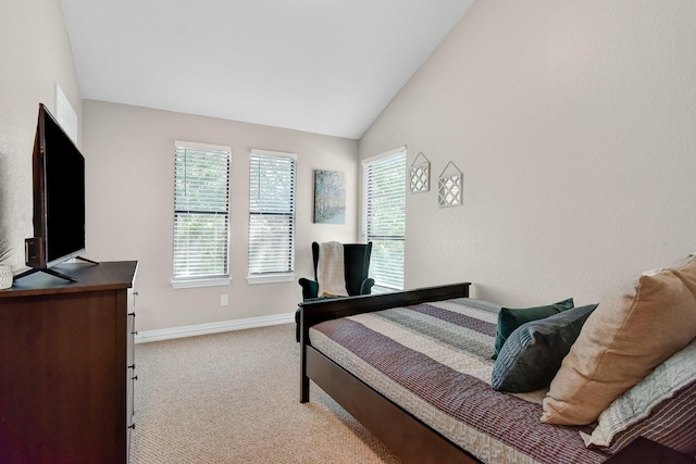 bedroom featuring carpet, baseboards, and vaulted ceiling