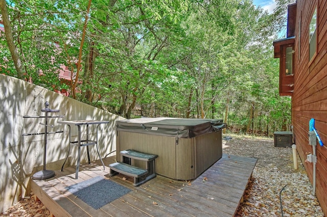 wooden deck with a hot tub