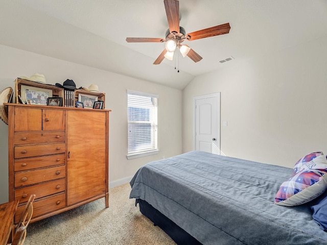 bedroom featuring light carpet, baseboards, visible vents, lofted ceiling, and ceiling fan