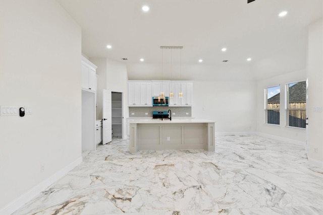 kitchen featuring tasteful backsplash, appliances with stainless steel finishes, light countertops, white cabinetry, and recessed lighting