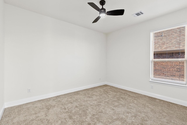 unfurnished room with ceiling fan, carpet flooring, visible vents, and baseboards