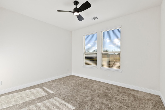 unfurnished room with a ceiling fan, baseboards, visible vents, and carpet flooring