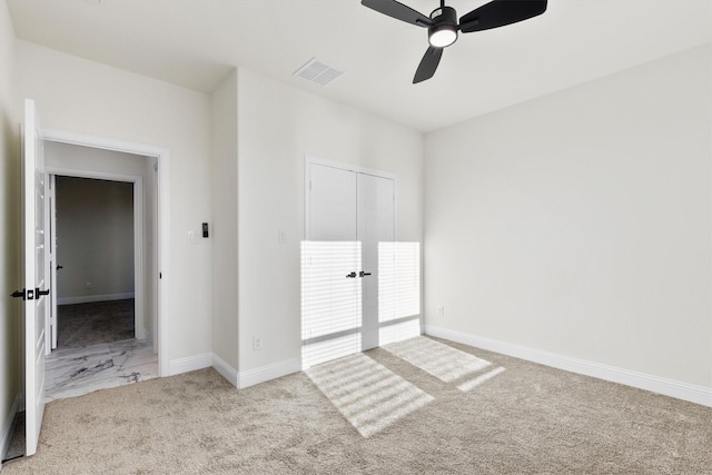 unfurnished bedroom with a ceiling fan, baseboards, visible vents, and carpet flooring