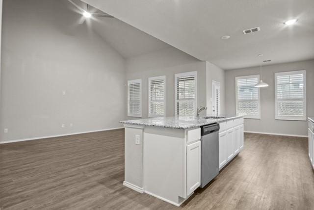 kitchen with dark wood-style floors, a center island with sink, visible vents, white cabinetry, and dishwasher