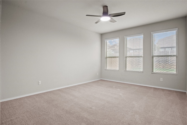 unfurnished room with light carpet, ceiling fan, and baseboards