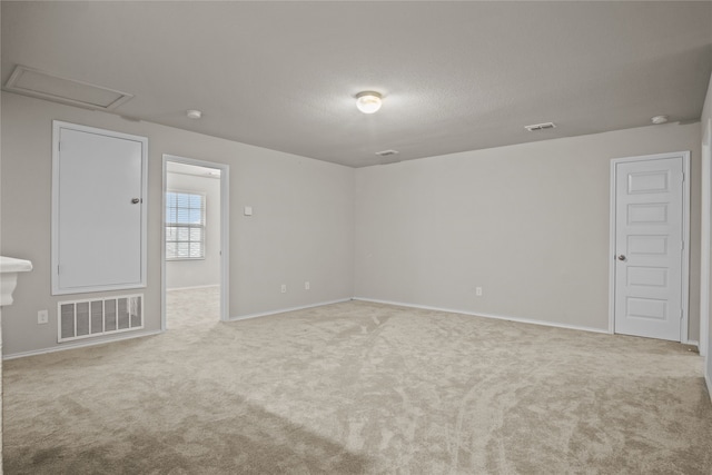 unfurnished room featuring baseboards, visible vents, a textured ceiling, and carpet flooring