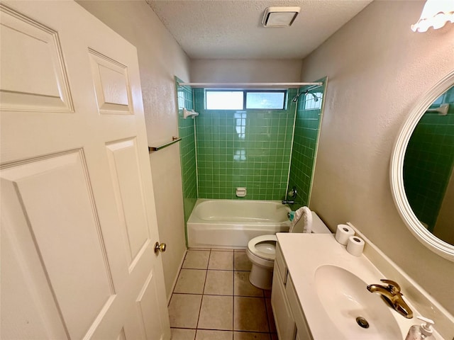 bathroom with a textured ceiling, tile patterned flooring, toilet, vanity, and shower / bathing tub combination