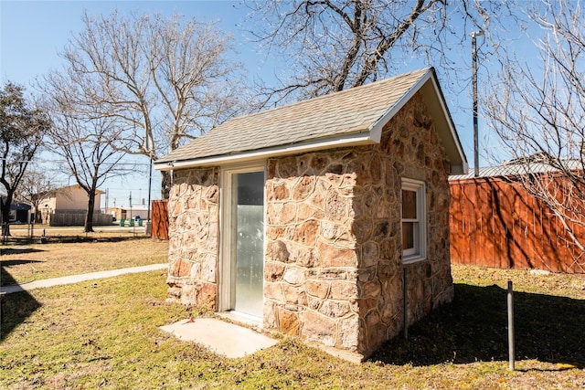 view of outbuilding with an outbuilding and fence