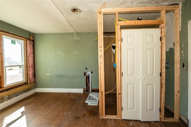 misc room with baseboards and hardwood / wood-style floors