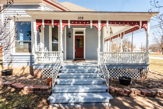 view of front of home with a porch and roof with shingles