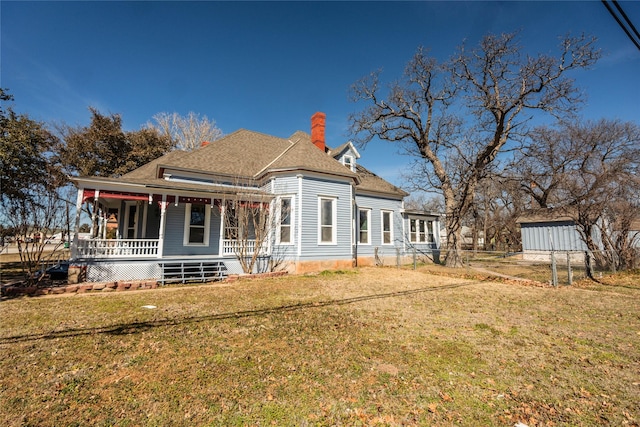 view of front of property featuring a porch, a front yard, and fence