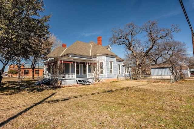 exterior space with covered porch and a front yard