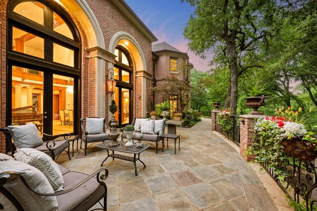900 Kingsbury Way, Southlake, TX 76092 - patio terrace at dusk featuring french doors, outdoor lounge area, and a patio area