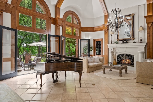 900 Kingsbury Way, Southlake, TX 76092 - living area with high vaulted ceiling, healthy amount of natural light, light tile patterned floors, a lit fireplace, and a chandelier