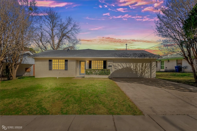 single story home featuring a garage, a front yard, concrete driveway, and brick siding