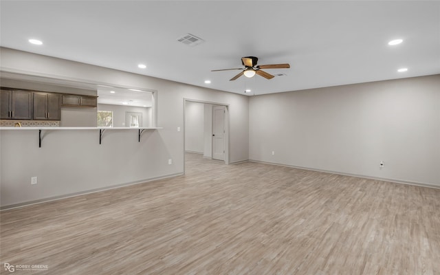 unfurnished living room with light wood-style floors, recessed lighting, and visible vents