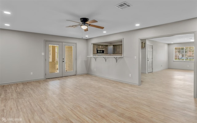 unfurnished living room featuring recessed lighting, visible vents, baseboards, french doors, and light wood-type flooring