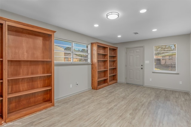 unfurnished room with recessed lighting, light wood-style flooring, and baseboards