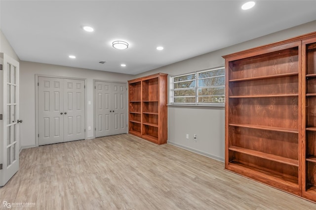 interior space featuring two closets, recessed lighting, visible vents, light wood-type flooring, and baseboards