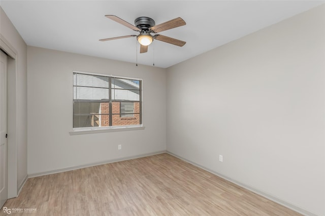 unfurnished room with ceiling fan, light wood-style flooring, and baseboards