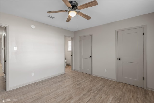 unfurnished bedroom featuring connected bathroom, a ceiling fan, visible vents, baseboards, and light wood finished floors