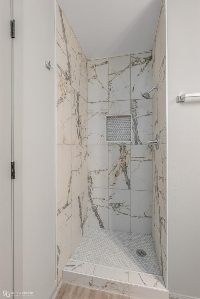 bathroom featuring a shower stall and wood finished floors