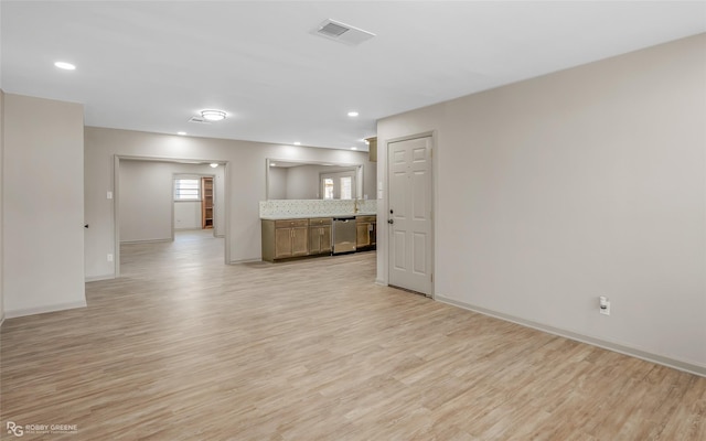 unfurnished living room with recessed lighting, visible vents, light wood-style flooring, and baseboards