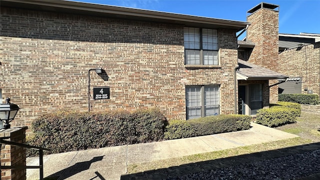 exterior space featuring brick siding