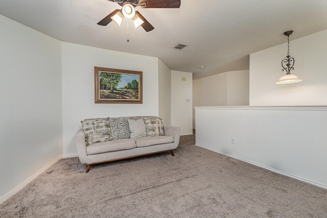 sitting room featuring visible vents, baseboards, ceiling fan, a textured ceiling, and carpet floors