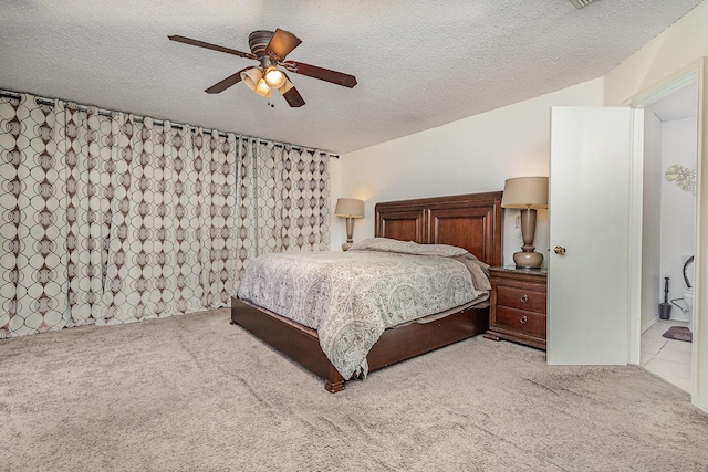 carpeted bedroom featuring a textured ceiling and a ceiling fan