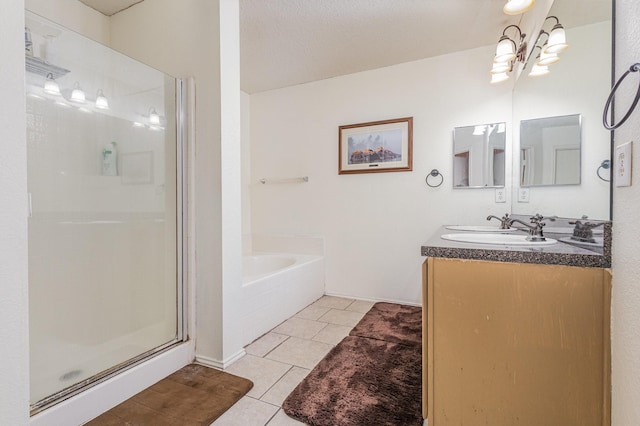 full bath featuring double vanity, a stall shower, a sink, tile patterned flooring, and a bath