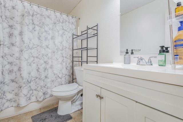 bathroom featuring tile patterned flooring, vanity, and toilet