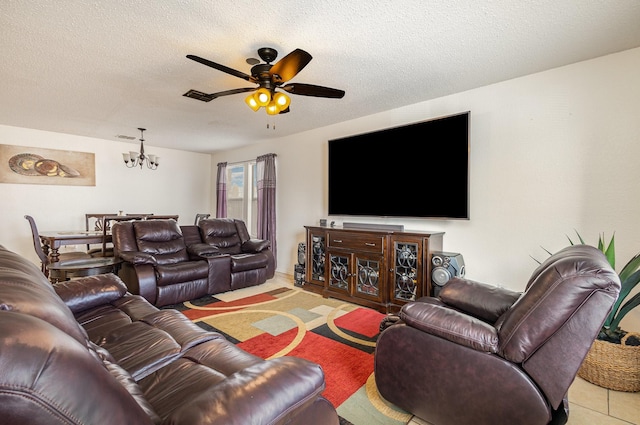 tiled living area with visible vents, a textured ceiling, and ceiling fan with notable chandelier