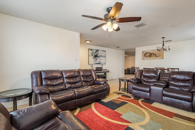 living area with ceiling fan with notable chandelier, visible vents, a textured ceiling, and light tile patterned flooring