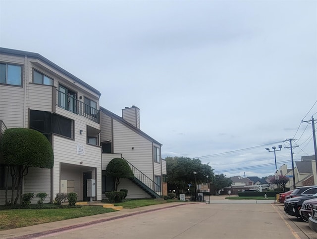 view of street featuring sidewalks, street lights, and curbs