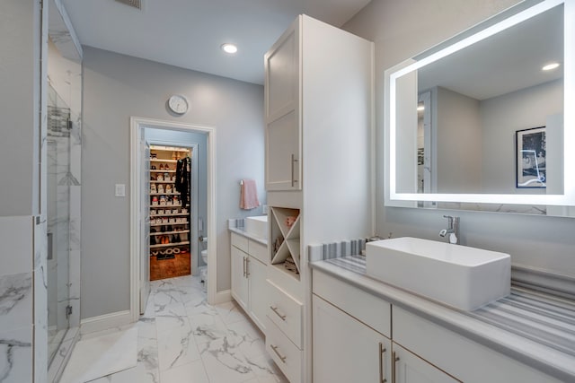 612 Skyline Bluff Dr, Fort Worth, TX 76102 - bathroom with marble finish floors, a shower stall, a walk in closet, vanity, and recessed lighting