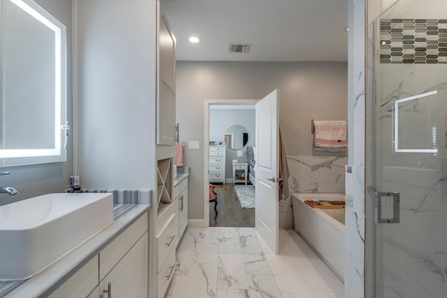 612 Skyline Bluff Dr, Fort Worth, TX 76102 - full bath with a shower stall, marble look tiles, a bath, recessed lighting, and vanity
