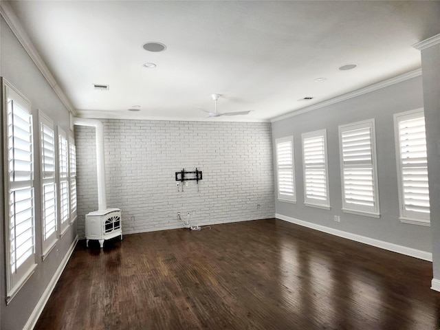 612 Skyline Bluff Dr, Fort Worth, TX 76102 - unfurnished living room with brick wall, healthy amount of natural light, a ceiling fan, a wood stove, and wood finished floors