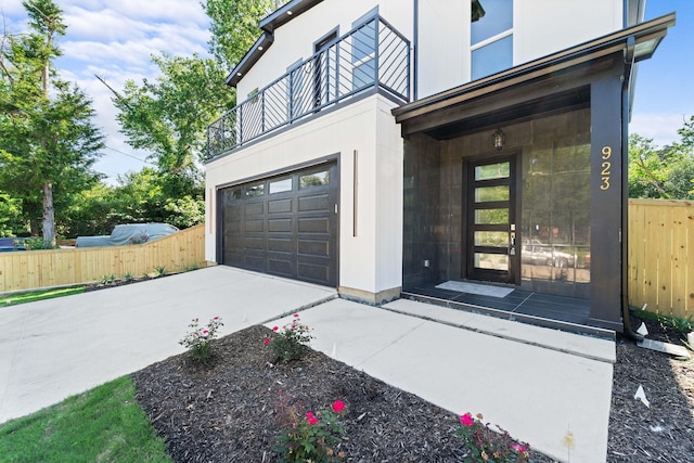 exterior space with concrete driveway and fence