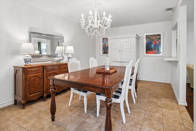 dining area with light tile patterned floors, baseboards, visible vents, and an inviting chandelier