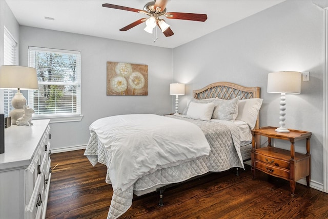 bedroom featuring baseboards, dark wood finished floors, and a ceiling fan