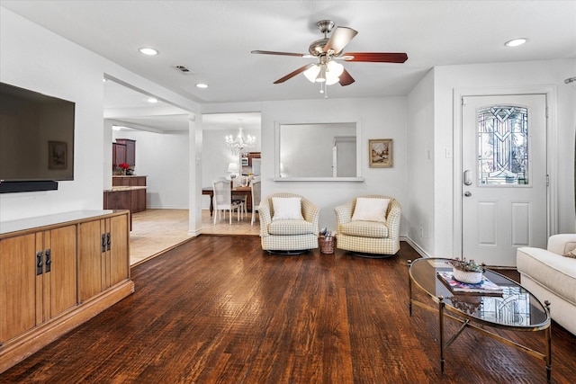 living room featuring recessed lighting, visible vents, wood finished floors, baseboards, and ceiling fan with notable chandelier