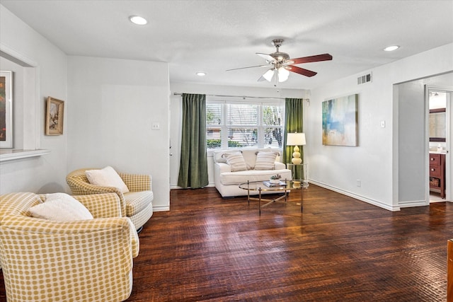 living room with recessed lighting, visible vents, baseboards, and wood finished floors