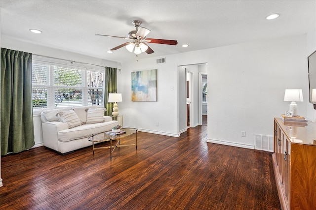 living area with recessed lighting, wood finished floors, visible vents, and baseboards