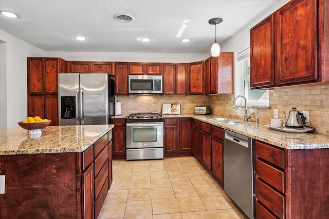 kitchen featuring appliances with stainless steel finishes, a sink, and dark brown cabinets