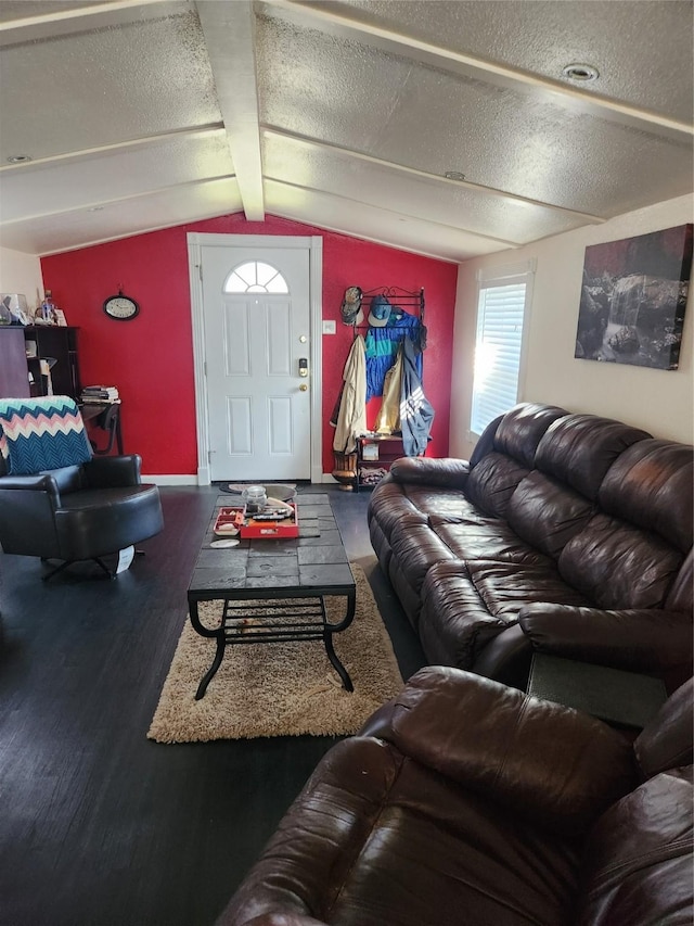 living room with lofted ceiling with beams, a textured ceiling, and wood finished floors