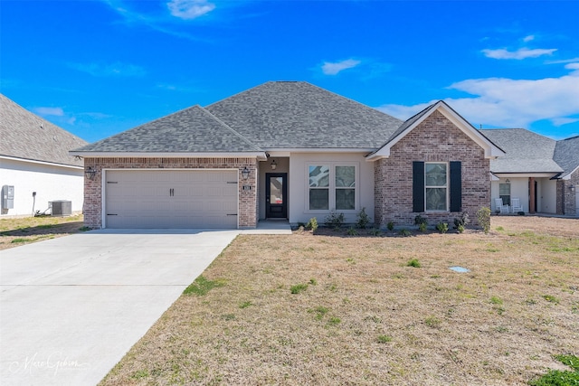 ranch-style house with a garage, driveway, a shingled roof, and central AC